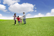 Happy Asian Family in Meadow