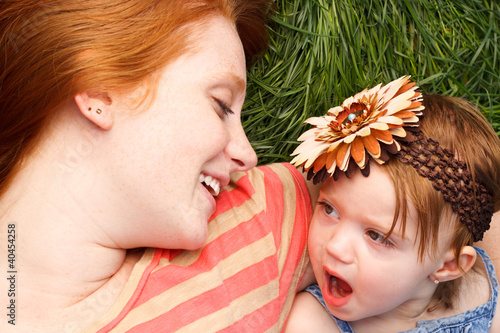 Photo: Smiling Mother And Daughter Laying In Tall Grass Smiling Mother And Daughter Laying In Tall Grass