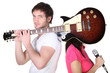 Guitarist covering his band mate's face