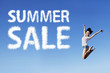 Happy woman jumping with a discount sign