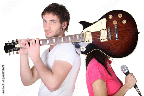 Photo: Guitarist covering his band mate's face Guitarist covering his band mate's face
