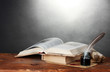 old books, scrolls, feather pen and inkwell