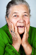 Happy and amazed old senior woman