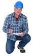 Builder writing on a piece of paper