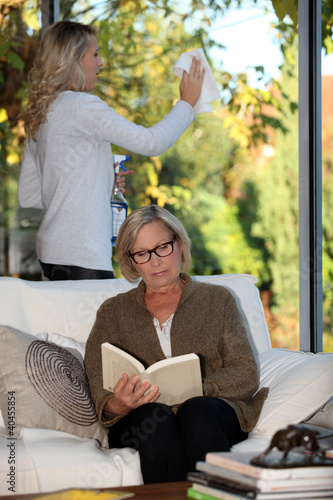 Photo: A housekeeper cleaning a window A housekeeper cleaning a window