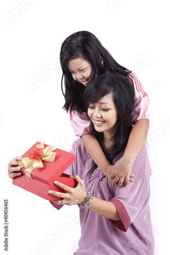 Photo: Daughter gives a surprised present to her mother Daughter gives a surprised present to her mother