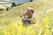 A couple sitting on the prairie enjoying the view.