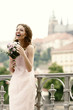 A lady happily holding a bouquet of flowers.