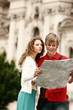 A man and woman referring to a map for direction.