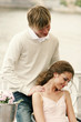 A guy giving his girlfriend a shoulder massage.