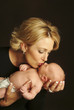A woman kissing a baby.