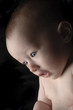 Close-u picture of a baby with big eyes.