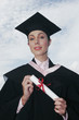 A lady in a robe and mortarboard holding a scroll.