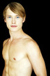 A shirtless muscular man looking at the camera.