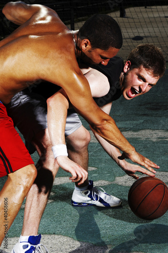 Photo: A player trying to snatch the ball from his opponent. A player trying to snatch the ball from his opponent.