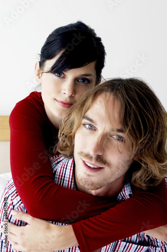 Photo: A lady locking her hands around her boyfriend's neck. A lady locking her hands around her boyfriend's neck.