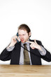 Photo: a man in business suit talking angrily on the phone. a man in business suit talking angrily on the phone.