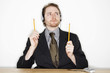 Photo: a man with headphone tapping along with pencils while listening to music connected from his handphone. a man with headphone tapping along with pencils while listening to music connected from his handphone.