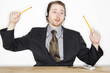 Photo: a man with headphone tapping along with pencils while listening to music connected from his handphone. a man with headphone tapping along with pencils while listening to music connected from his handphone.