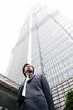 Man in business suit standing in front of the building. 