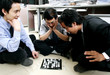A group of men playing chess in the office. 