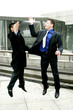 Photo: Two men in business suit giving high five. Two men in business suit giving high five.