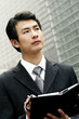 Foto: Man in business suit writing his organizer. Man in business suit writing his organizer.
