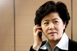 Photo: A woman talking on the handphone. A woman talking on the handphone.