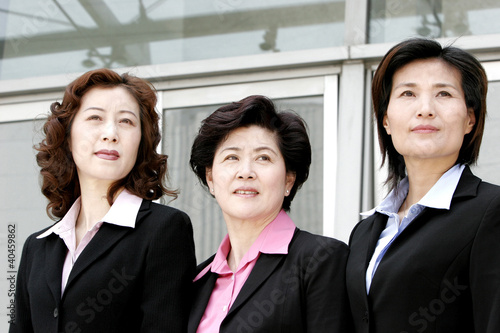 Photo: Three women in formal wear. Three women in formal wear.
