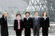 Photo: A bald man watching a group of business people standing in a row. A bald man watching a group of business people standing in a row.