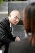 Foto: A bald man in business suit looking at a girl. A bald man in business suit looking at a girl.