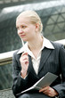 Photo: A woman holding an organizer and a pen. A woman holding an organizer and a pen.