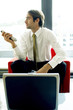 Photo: Man controlling the air-conditioner with a remote control. Man controlling the air-conditioner with a remote control.