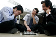 Three men playing chess in the office. 