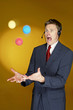 Man trying to juggle with three balls. 
