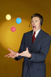 Man trying to juggle with three balls. 