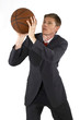 Man in business suit trying to shoot a basketball. 