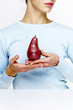 Woman holding a red pear.