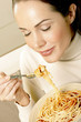 Woman enjoying a bowl of spaghetti.