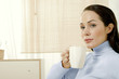 Woman holding a cup of coffee.