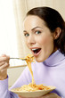 Woman having a bowl of spaghetti.
