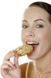 Woman eating cookies.