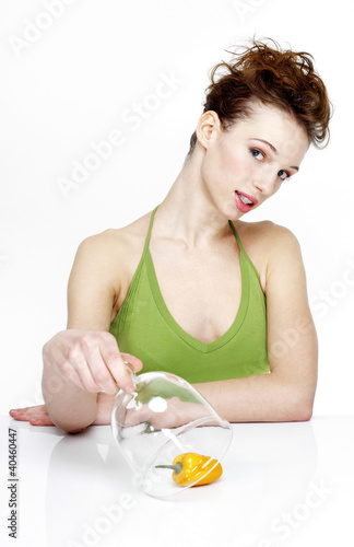 Photo: Woman covering up a yellow capsicum. Woman covering up a yellow capsicum.