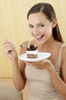 Woman holding a plate of cake.