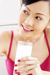 Woman holding a glass of milk.