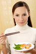 Woman enjoying japanese cuisine.
