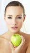 Woman holding a green apple.