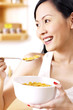 Woman enjoying a bowl of breakfast cereal.