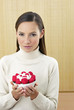 Woman holding a bowl of strawberries.