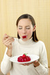 Woman eating jelly.